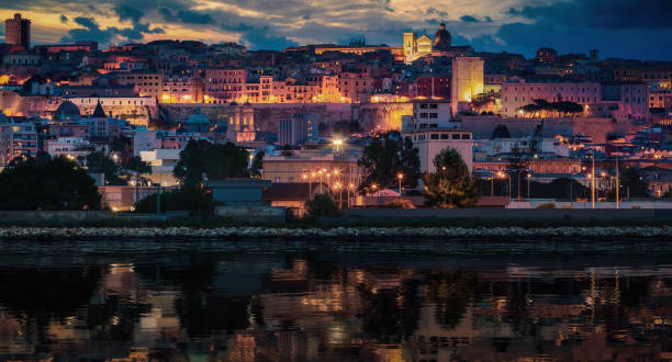 Cagliari Old-Town Reflections: Illuminated Skyline and Water at Dusk stock photo