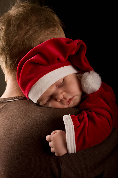 istock Christmas baby sleeping on fathers shoulders 157399587