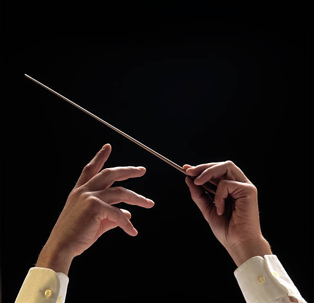 istock Conductors hands with baton on black background 157399632