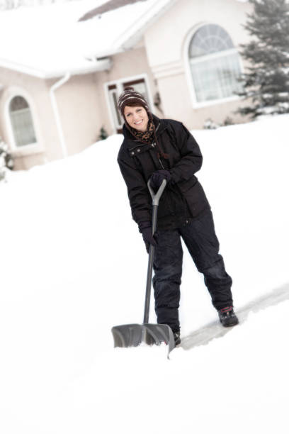 istock Female snow shoveler 157399796