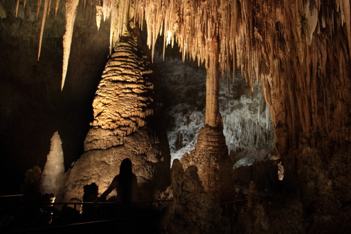 A silhouetted visitor on the Big Room Route enjoys the Temple of the Sun, a group of columns, stalagmites and stalactites in Carlsbad Caverns National Park located in the Guadalupe Mountains in southeastern New Mexico.