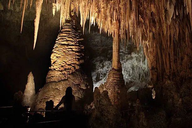 A silhouetted visitor on the Big Room Route enjoys the Temple of the Sun, a group of columns, stalagmites and stalactites in Carlsbad Caverns National Park located in the Guadalupe Mountains in southeastern New Mexico.