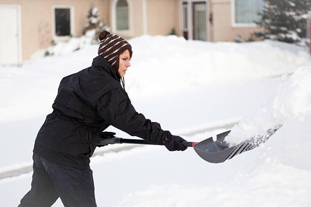 istock Female snow shoveler 157399990
