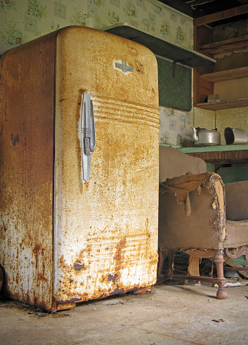 A spooky run down kitchen in an abandoned house.