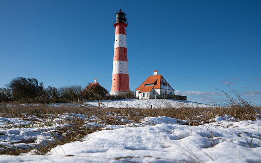 Panoramic image of Westerhever lighthouse during wintertime, North Frisia, Germany