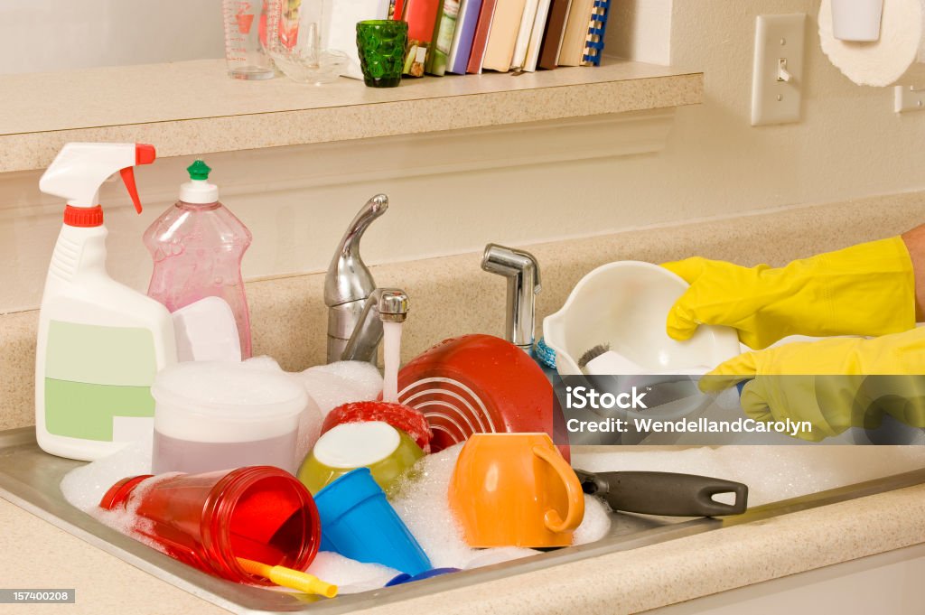 Washing Dishes Washing a sink full of dishes. Chores Stock Photo