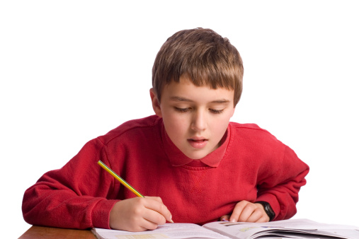Elementary school students writing a test.