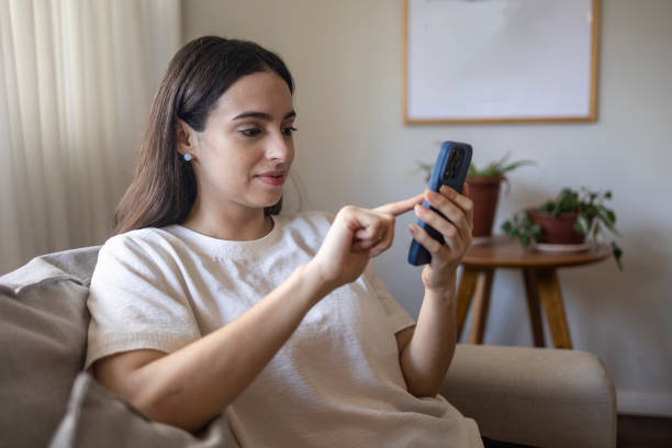istock Woman controlling air conditioner by cell phone 1574002771