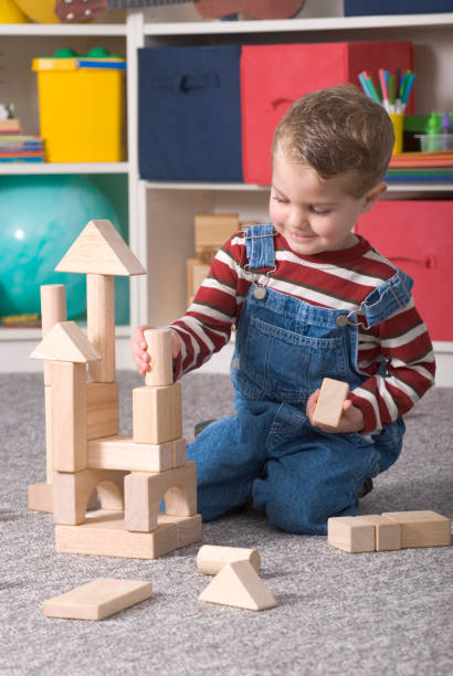 istock Young Boy Building With Wooden Toy Blocks 157400430