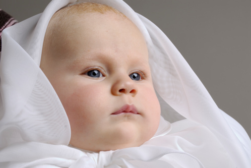 baby portrait wearing christening dress