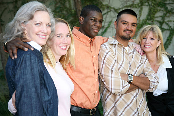 istock Diverse Group Of People Embracing And Smiling Together 157400830