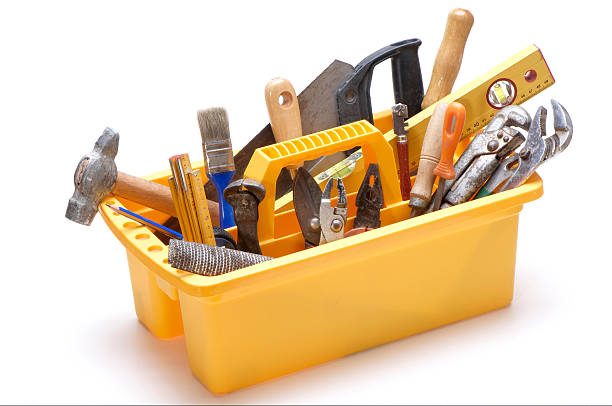 Yellow open toolbox with handle filled with tools stock photo