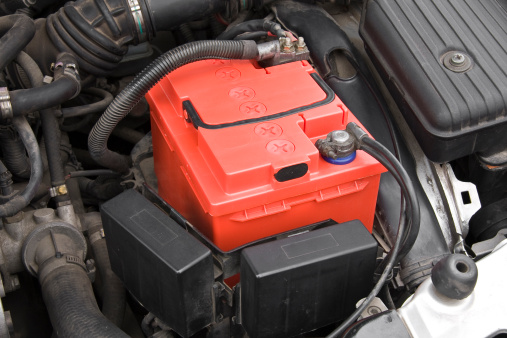 The car battery of the automobile electrical system in the engine compartment for car maintenance and recycle electronics garbage