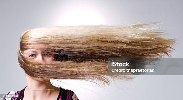 Woman Facing Straight Ahead With Hair Being Blown Aside Stock Photo - Download Image Now