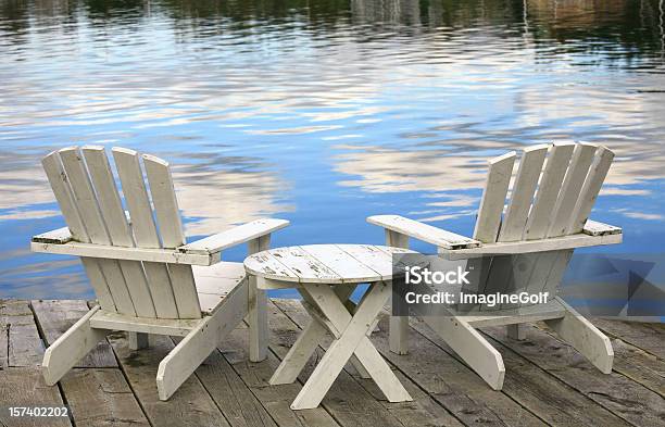 Two White Adirondack Chairs Stock Photo - Download Image Now - Chair, Adirondack Chair, Table