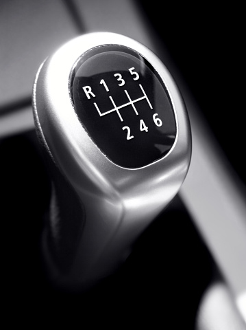 close up of a Metall six-Gear-stick from an modern new Sports Car, black and white, vertical shot 
