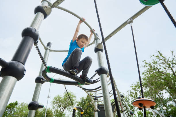istock Little boy plays and climbing on a ropes playground 1574022619