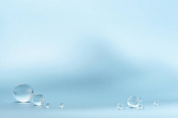 istock Blue background with transparent glass balls. 1574028347