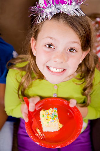A happy young girl at a birthday party.