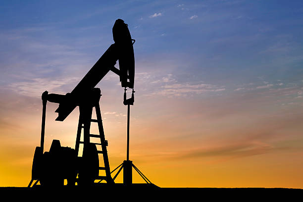 istock Dawn over petroleum pumps in the desert 157402882