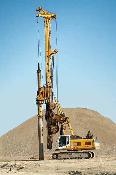 Photo of Machine Digging Foundational Pillars