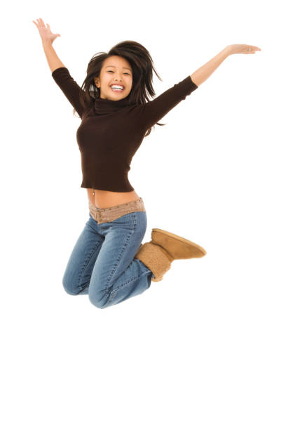istock Energetic Young Woman Jumping 157402908