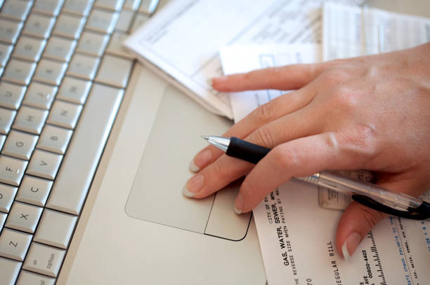 istock Close-up of woman's hand using trackpad to pay bills online 157402960