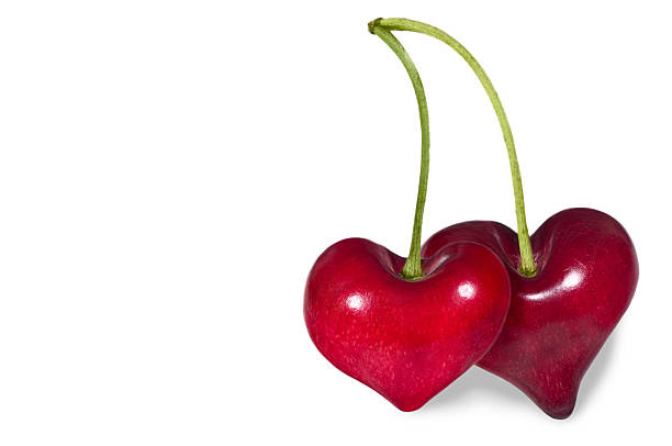 Togetherness Pair of Cherry Hearts isolated on white with clipping path. cherry colored stock pictures, royalty-free photos & images