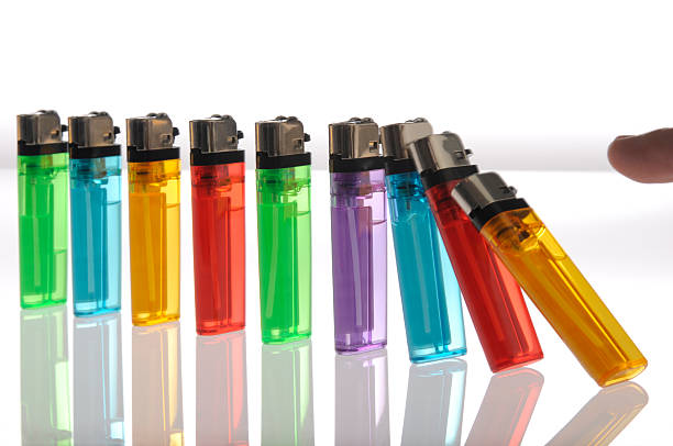 istock Colorful Disposable Cigarette Lighters Lined-Up, Pushed Over, Falling Like Dominoes 157403691
