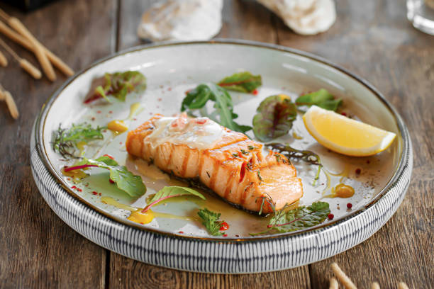 istock Baked salmon fillet steak with lemon and herbs 1574037451