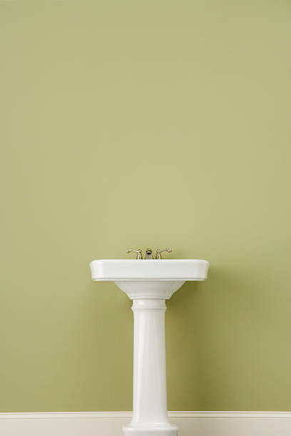 Sink on Green Wall  bathroom sink stock pictures, royalty-free photos & images