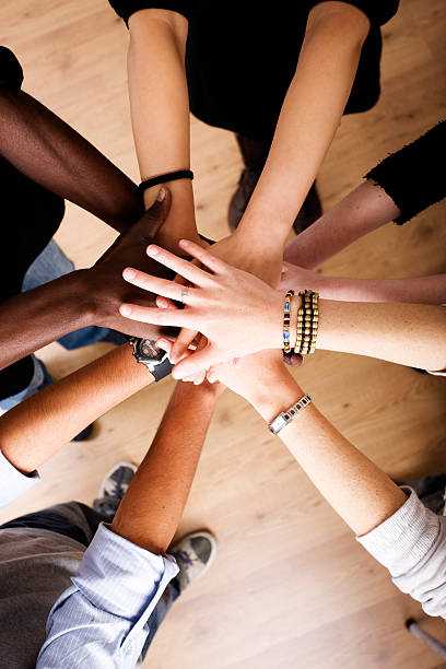istock Hands of different colors on top of one another 157404203