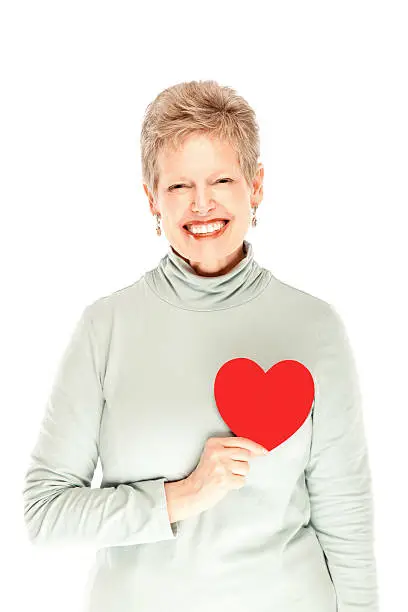 Photo of Beautiful mature female holding heart smiling