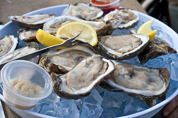 Dozen Raw Oysters  food poisoning stock pictures, royalty-free photos & images