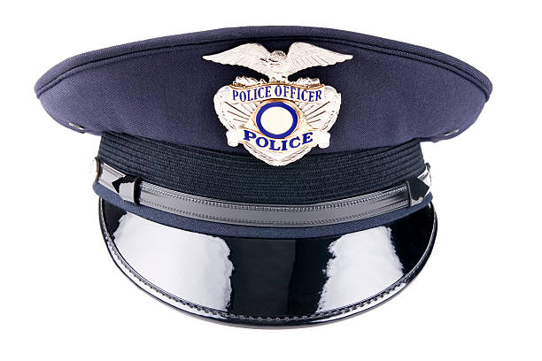 A blue police cap against a white background Front view of a generic police cap usually used for dress uniform and special events. hat stock pictures, royalty-free photos & images