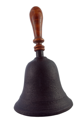 A metal service ringing bell in retro style that placed on the receiption desk. Object photo. Selective focus.