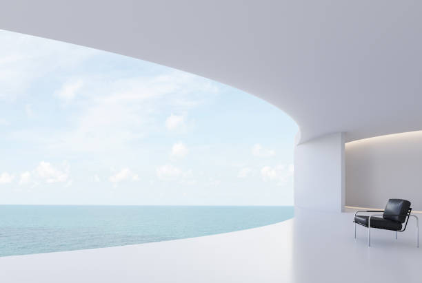 Minimal style curve white house curve terrace with sea view 3d render decorated with black leather chair with copy space