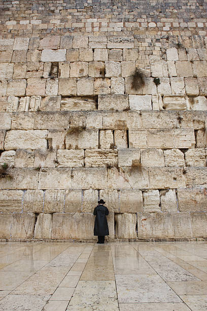 Praying Under Rain at the Western Wall  wailing wall stock pictures, royalty-free photos & images
