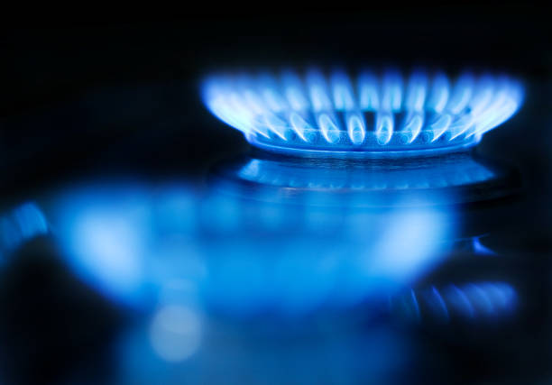Blue gas flame on a black background stock photo