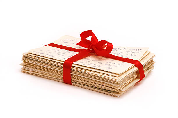Stack of old love letters bonded with red ribbon