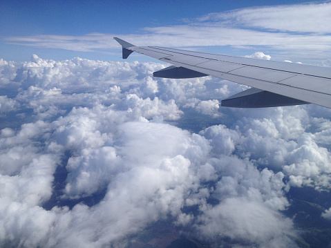 Airplane flying over tropical sea atduring sunset,copy space for text.