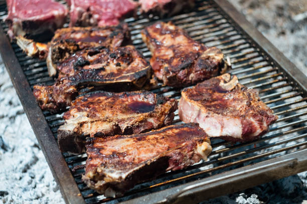 istock raw Agrentina beef steak bone cooking on bbq  grill 1574081936