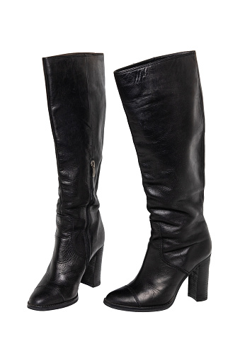 A pair of black elegant female boots or woman shoes isolated on a white background. Leather boots.