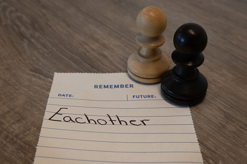 Concept - Remember note saying eachother with black and white chess pieces showing diversity - remeber eachother for mental health and relationships.