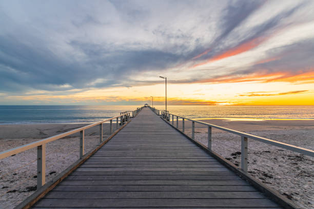 istock Henley Beach pier at sunset with the tranquil sea 1574129382