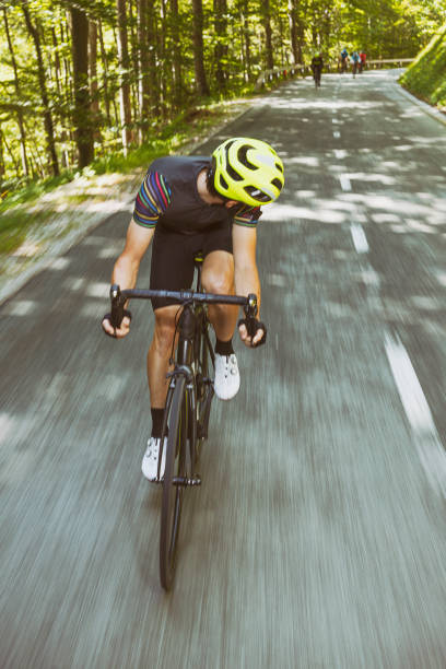 istock Bicycle rider in front of his friends 1574154672
