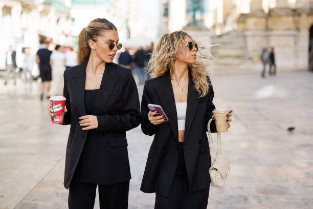 istock Young businesswomen using phone outdoors 1574171902