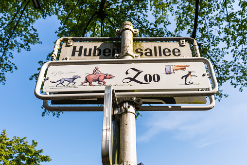 Wuppertal, Germany - May 3, 2022: Signpost and street sign to Wuppertal Zoo in North Rhine-Westphalia, Germany.