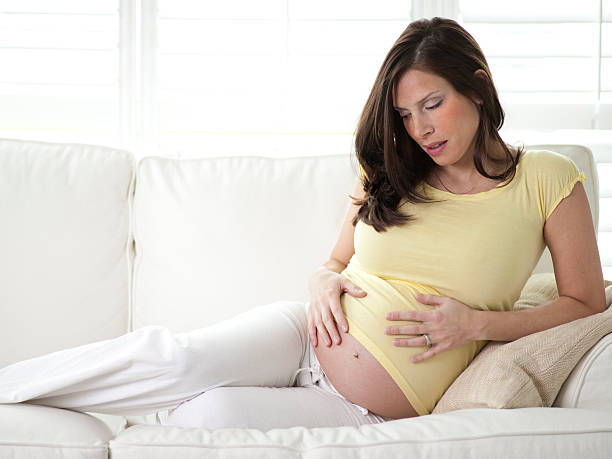 istock Pregnant woman relaxing on a couch 157418152