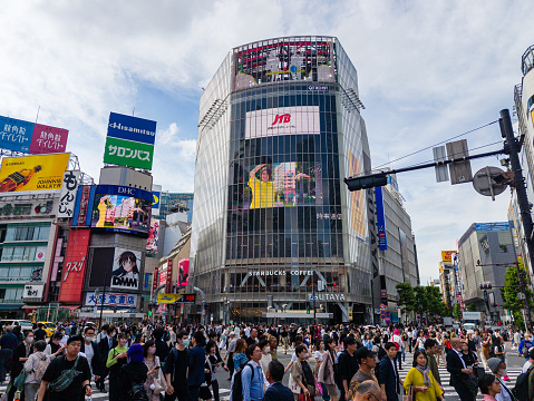 Crowds of tourists and pedestrians at the famous Shibuya Scramble Crossing in central Tokyo. Shibuya is allegedly the busiest crossing in the world.